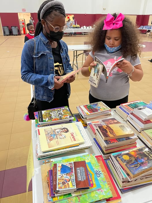 Young readers exploring books at a community literacy event