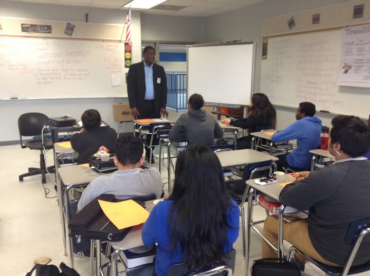 Guest mentor speaking to high school students about entrepreneurship